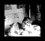 Gameboy Camera photo of a man lounging indoors
